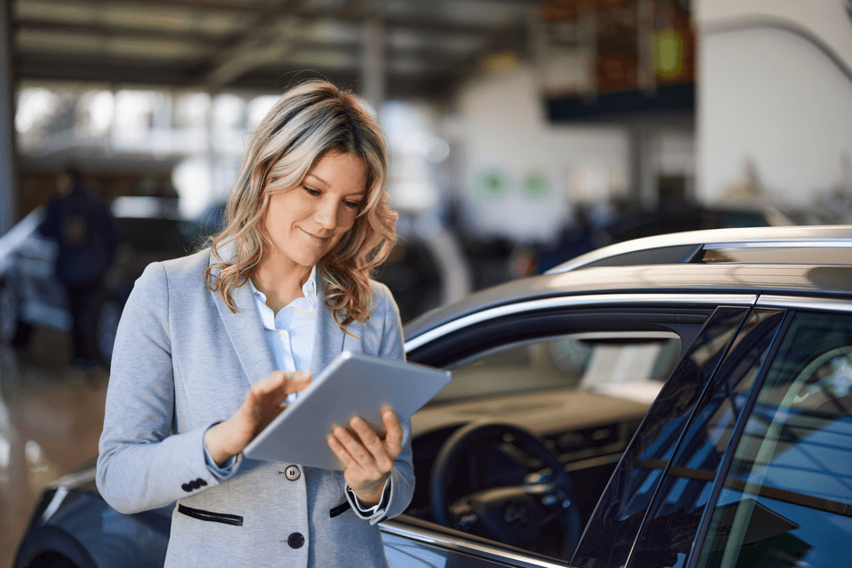 female salesperson on the sales floor of an auto dealership