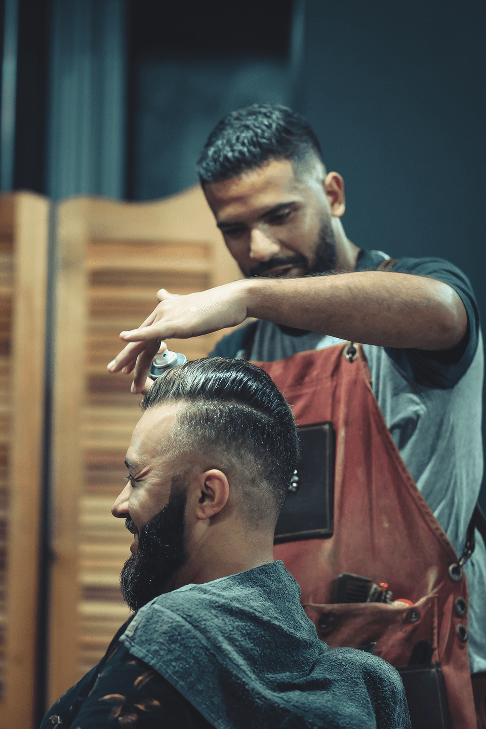 barber cutting a customer's hair
