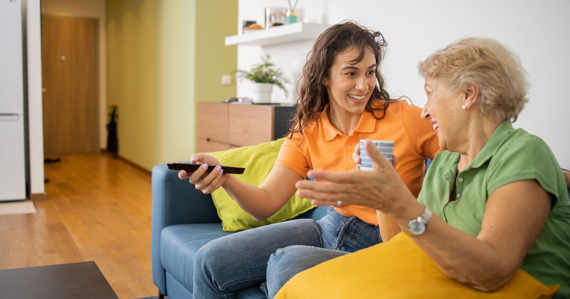 two generations of women watching tv in hospital