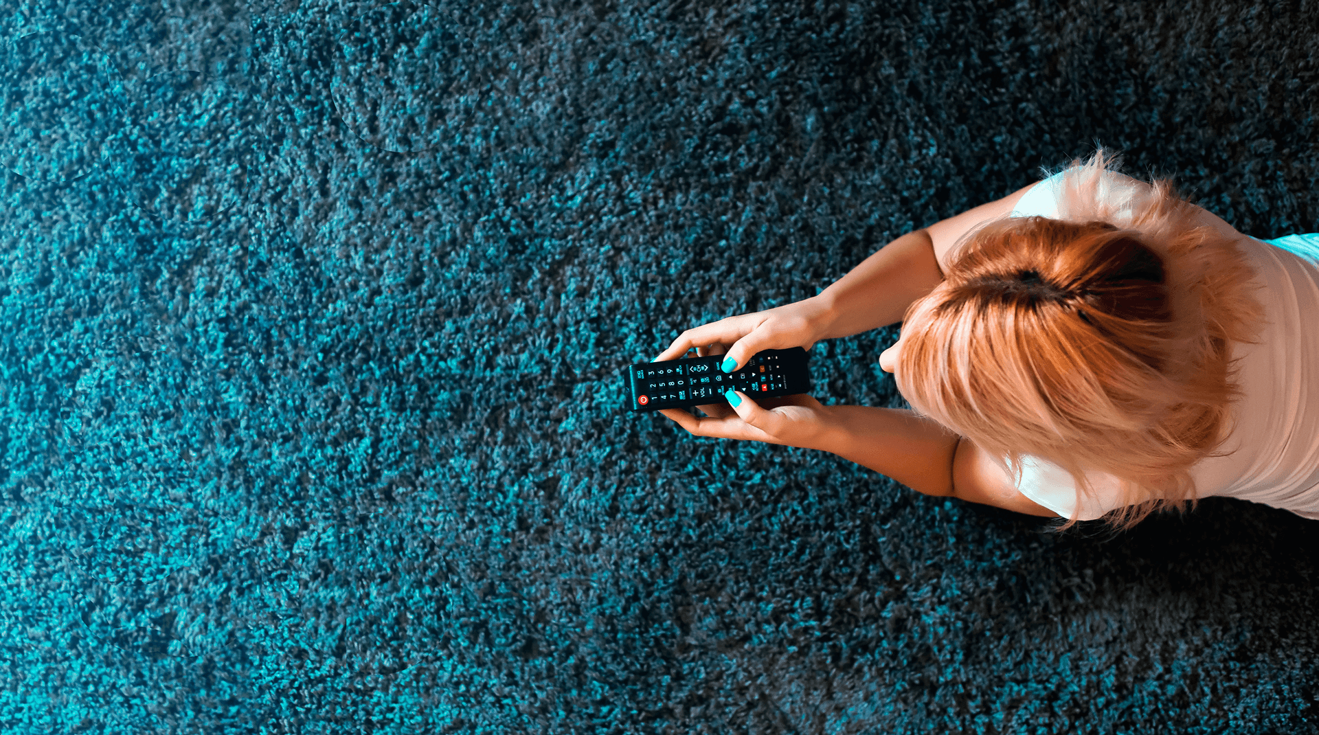 Woman on carpet with remote control