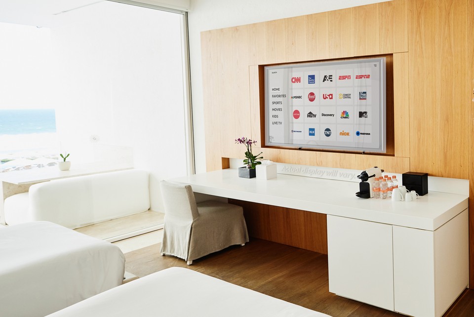 hotel room with tv displaying network logos