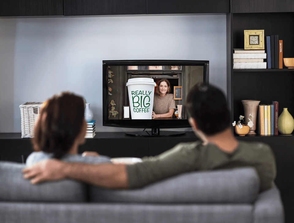 couple watching a commercial on tv